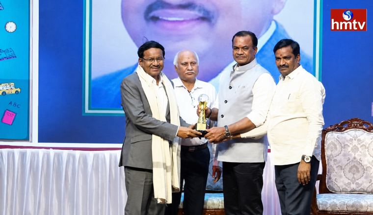 The Executive Director receiving an award on stage